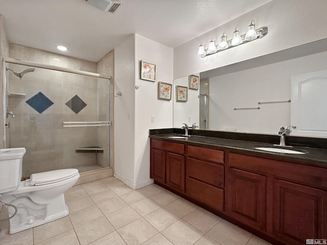 bathroom featuring vanity, a textured ceiling, tile patterned floors, toilet, and walk in shower