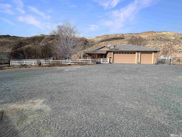 view of front facade featuring a garage and a mountain view