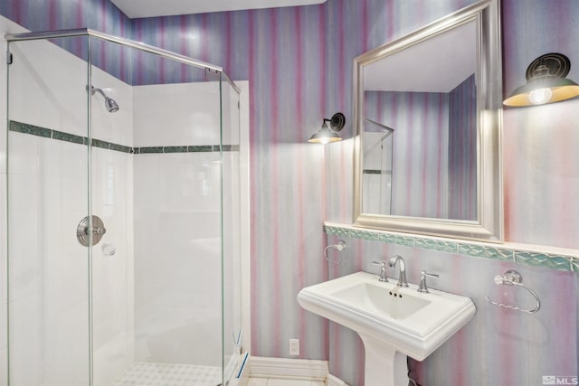 bathroom with an enclosed shower and sink