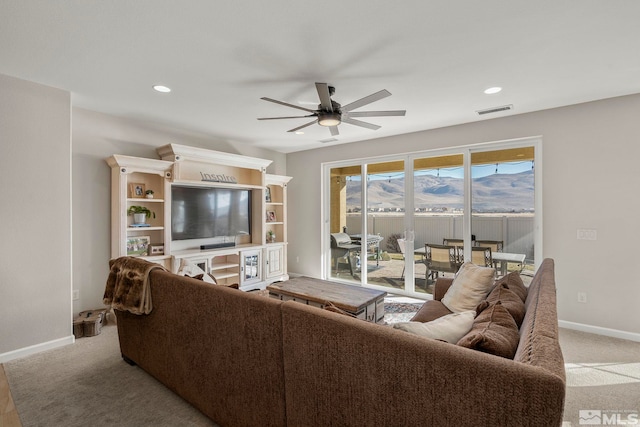 living room with ceiling fan and light carpet