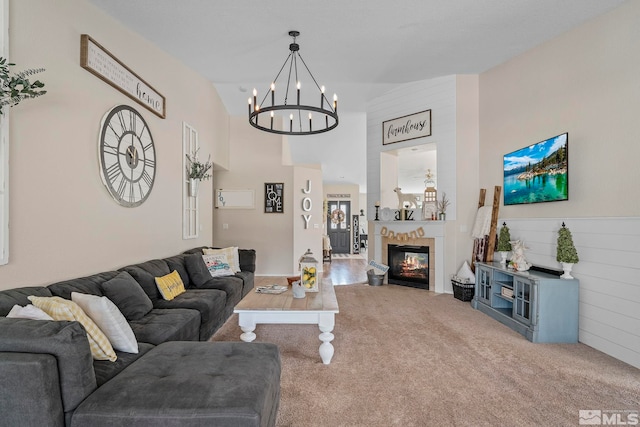 living room with vaulted ceiling, a tile fireplace, and carpet