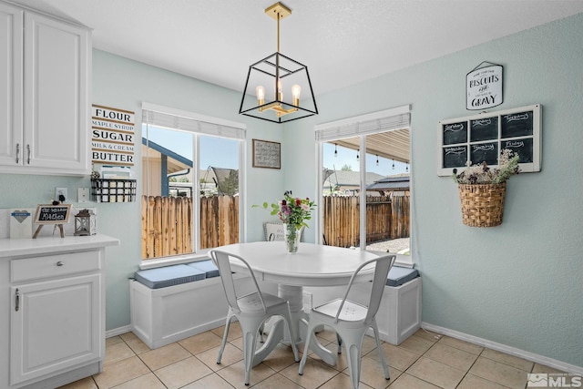 dining space featuring light tile patterned floors and a chandelier