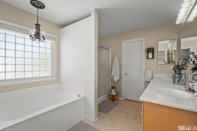 bathroom featuring vanity, a notable chandelier, and plus walk in shower