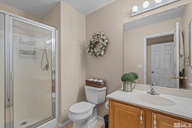 bathroom featuring vanity, toilet, and a shower with door