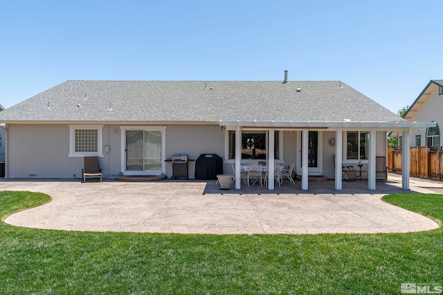 back of property featuring a patio area and a lawn