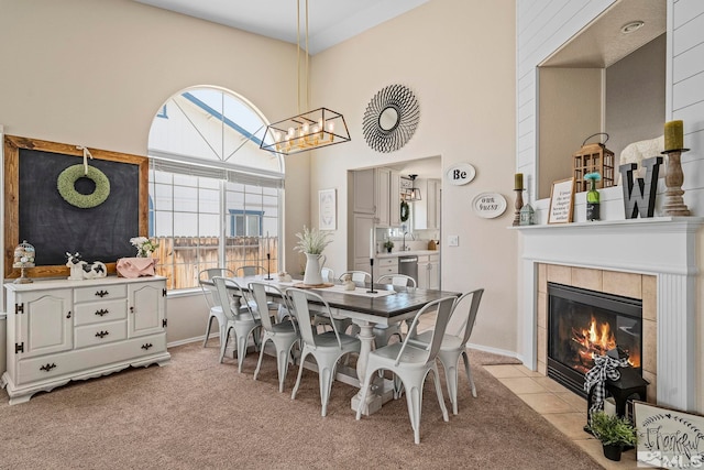 carpeted dining area with a fireplace