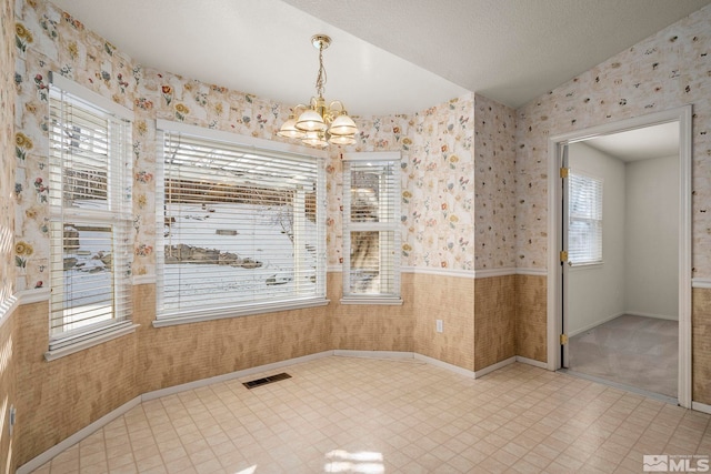 spare room featuring a notable chandelier