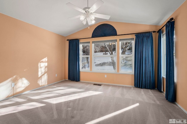 unfurnished room featuring lofted ceiling, light colored carpet, and ceiling fan