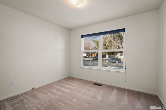 empty room featuring light carpet