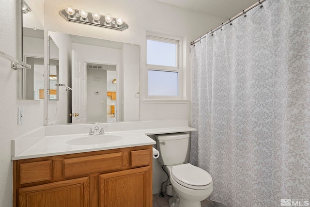 bathroom featuring vanity and toilet