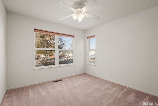 carpeted spare room with ceiling fan