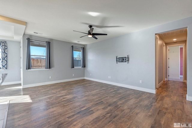 empty room with dark wood-type flooring and ceiling fan