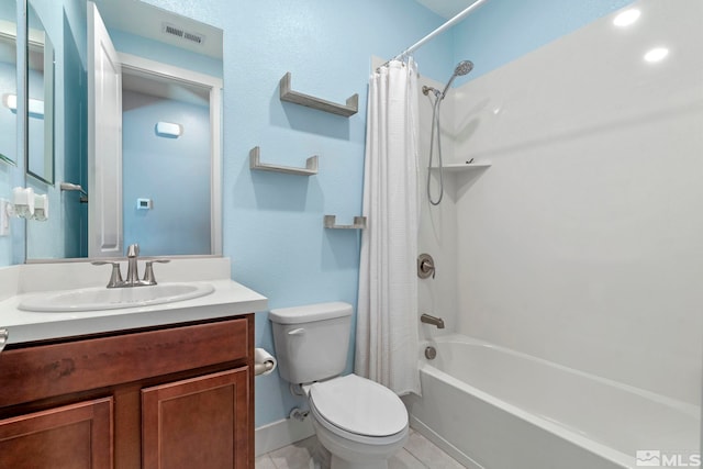 full bathroom with shower / tub combo with curtain, vanity, tile patterned flooring, and toilet