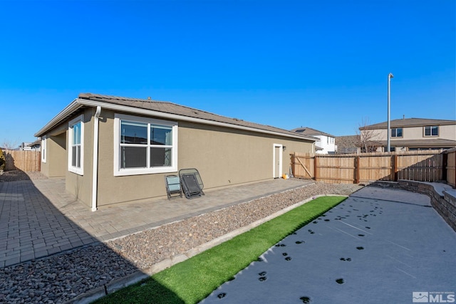 rear view of property featuring a patio area