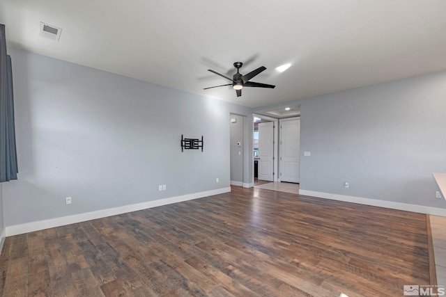 empty room with dark wood-type flooring and ceiling fan