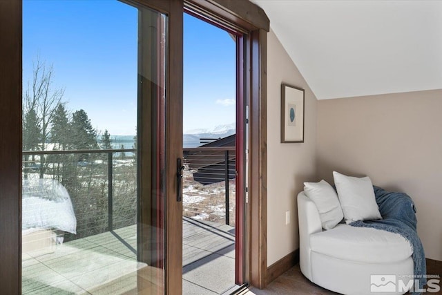 doorway to outside featuring lofted ceiling