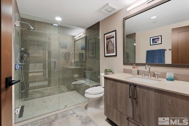 bathroom with vanity, an enclosed shower, and toilet