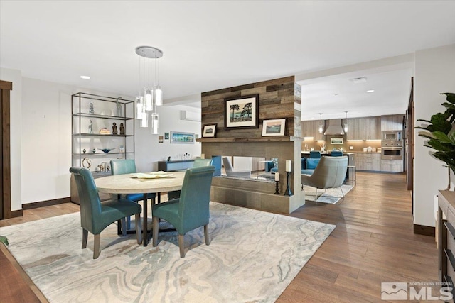 dining area with hardwood / wood-style floors and a chandelier