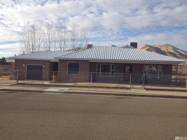 view of front of house with a garage and a mountain view