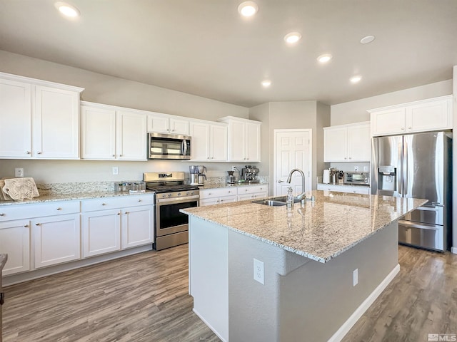 kitchen featuring sink, white cabinetry, a kitchen island with sink, stainless steel appliances, and light hardwood / wood-style floors