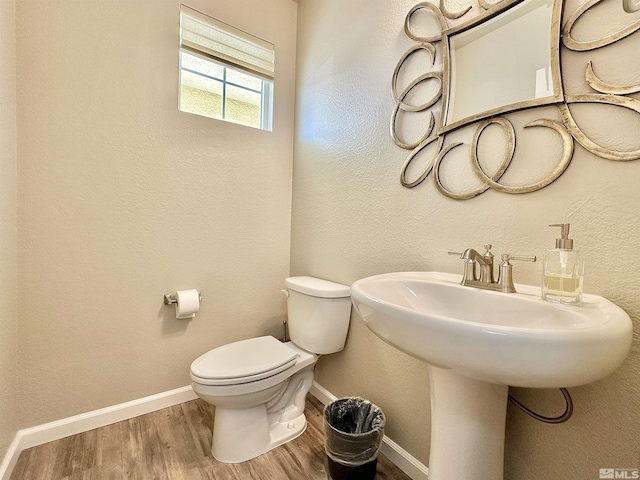 bathroom featuring hardwood / wood-style floors and toilet