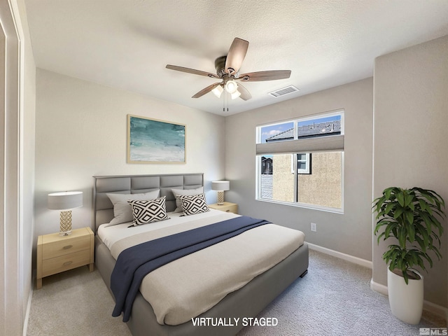 bedroom featuring ceiling fan and a textured ceiling