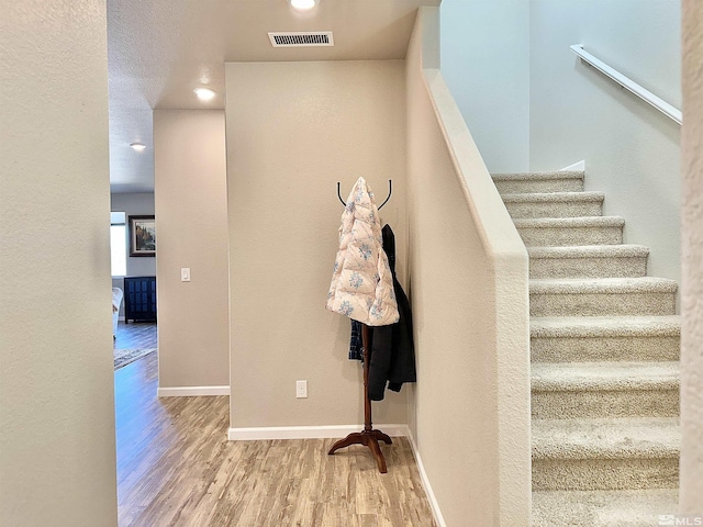 stairs with hardwood / wood-style floors