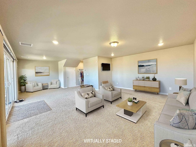 carpeted living room with a textured ceiling