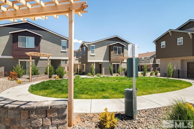 view of community with a yard and a pergola