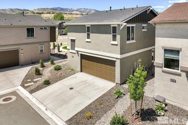 view of front property featuring a mountain view and a garage