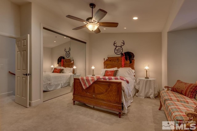 bedroom featuring light carpet, a closet, and ceiling fan