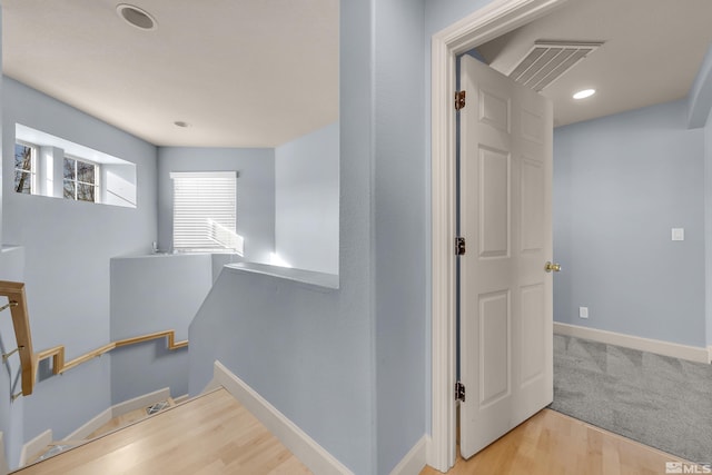 stairs featuring wood-type flooring