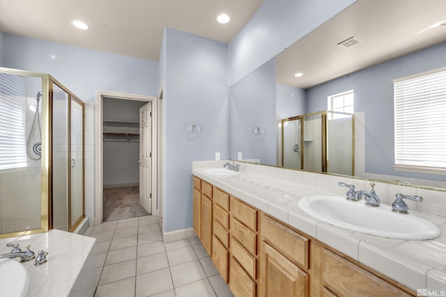 bathroom with vanity, tile patterned floors, and shower with separate bathtub