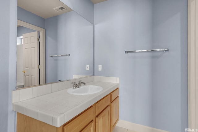 bathroom with vanity and tile patterned flooring