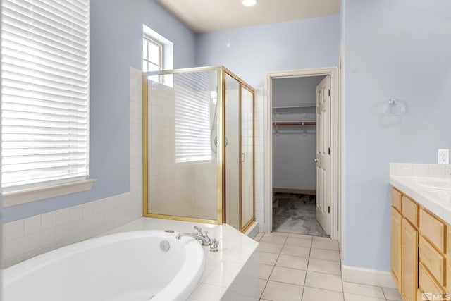 bathroom featuring tile patterned flooring, vanity, and separate shower and tub