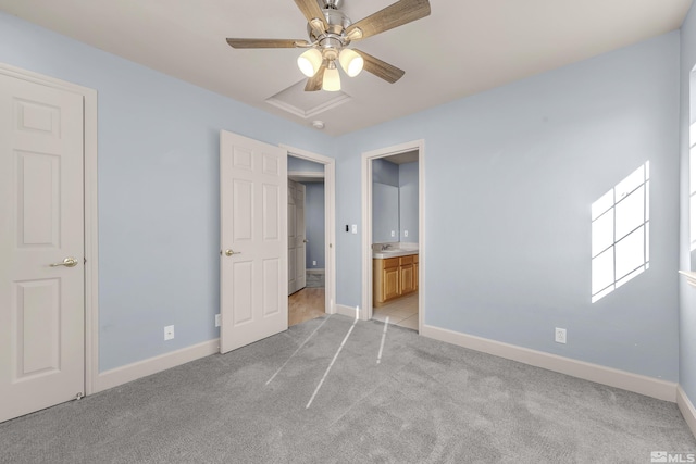 unfurnished bedroom featuring sink, ensuite bath, light colored carpet, and ceiling fan