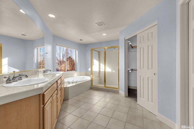 bathroom with vanity, plus walk in shower, and tile patterned flooring