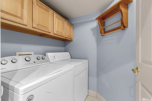 laundry area with cabinets, light tile patterned floors, and independent washer and dryer