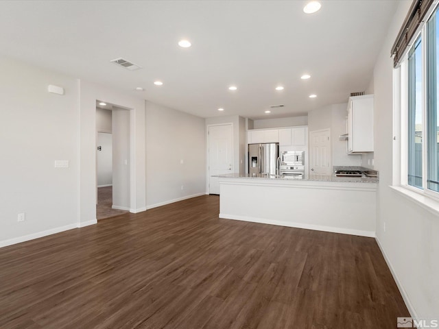 unfurnished living room featuring dark wood-type flooring