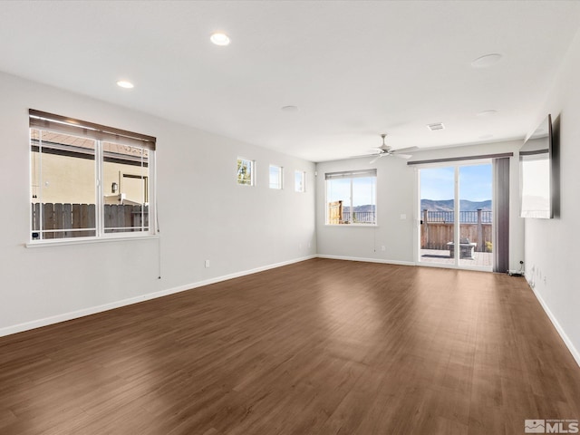 unfurnished room featuring dark wood-type flooring and ceiling fan