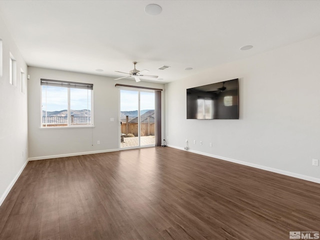 spare room with dark wood-type flooring and ceiling fan