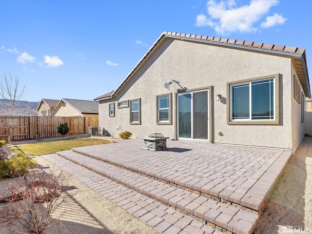 back of house featuring a fire pit, a patio area, and central air condition unit