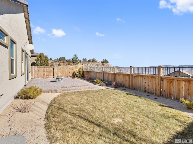 view of yard featuring an outdoor fire pit and a patio area