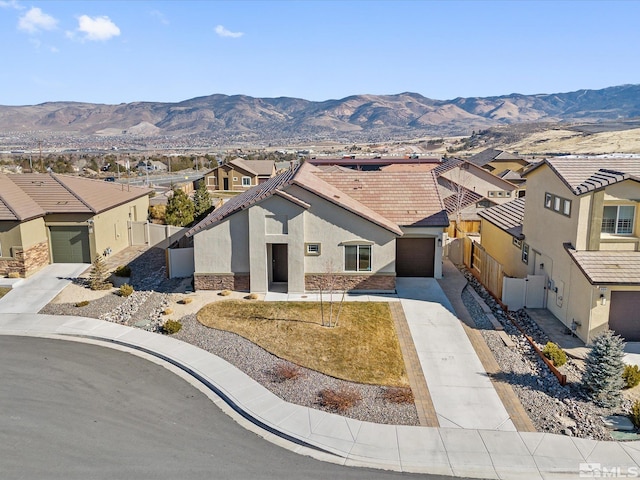 view of front of home with a garage and a mountain view