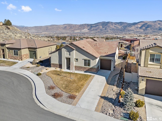 view of front facade featuring a garage and a mountain view