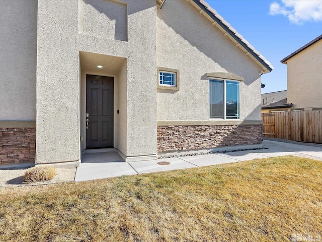 doorway to property featuring a lawn