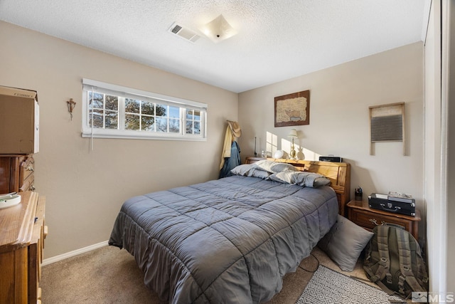 carpeted bedroom featuring a textured ceiling