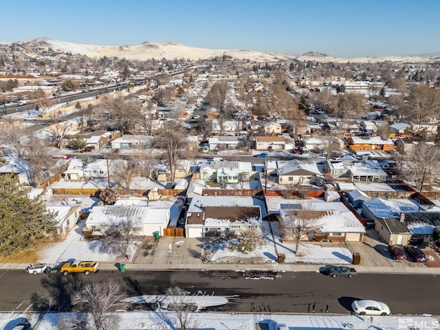 snowy aerial view featuring a mountain view