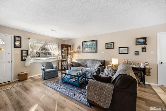 living room with hardwood / wood-style flooring and a textured ceiling