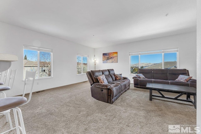 living room with a healthy amount of sunlight and light carpet